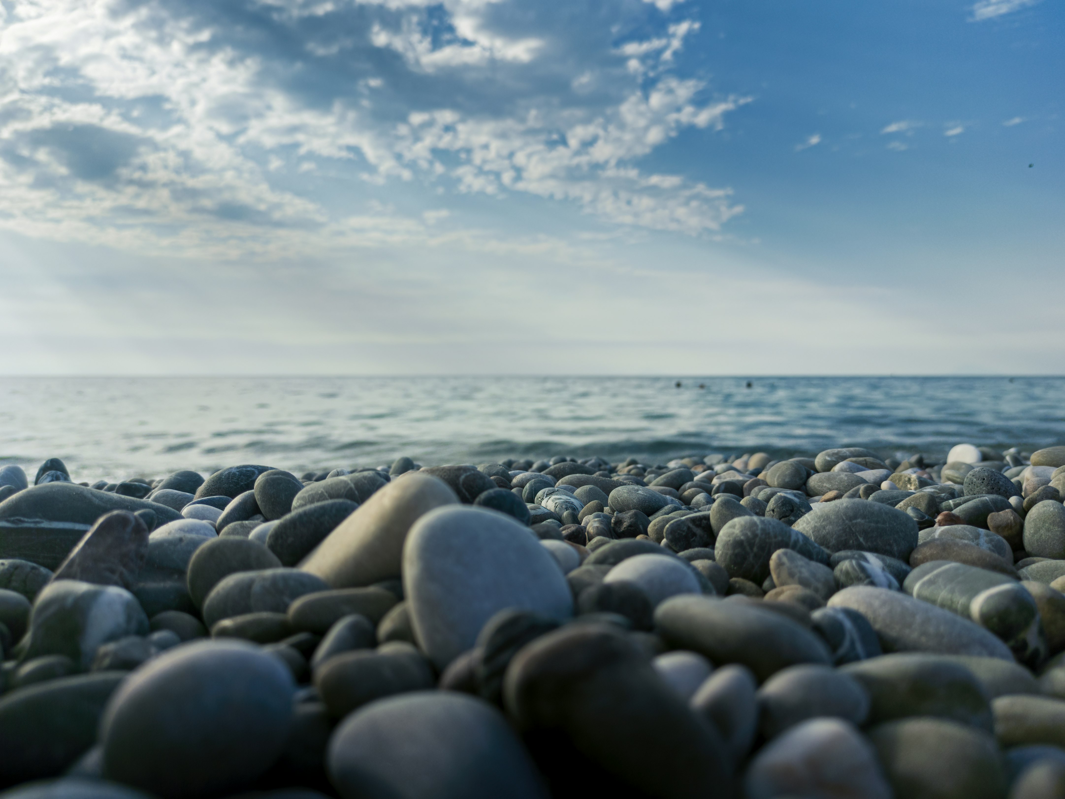 black stones on seashore during daytime